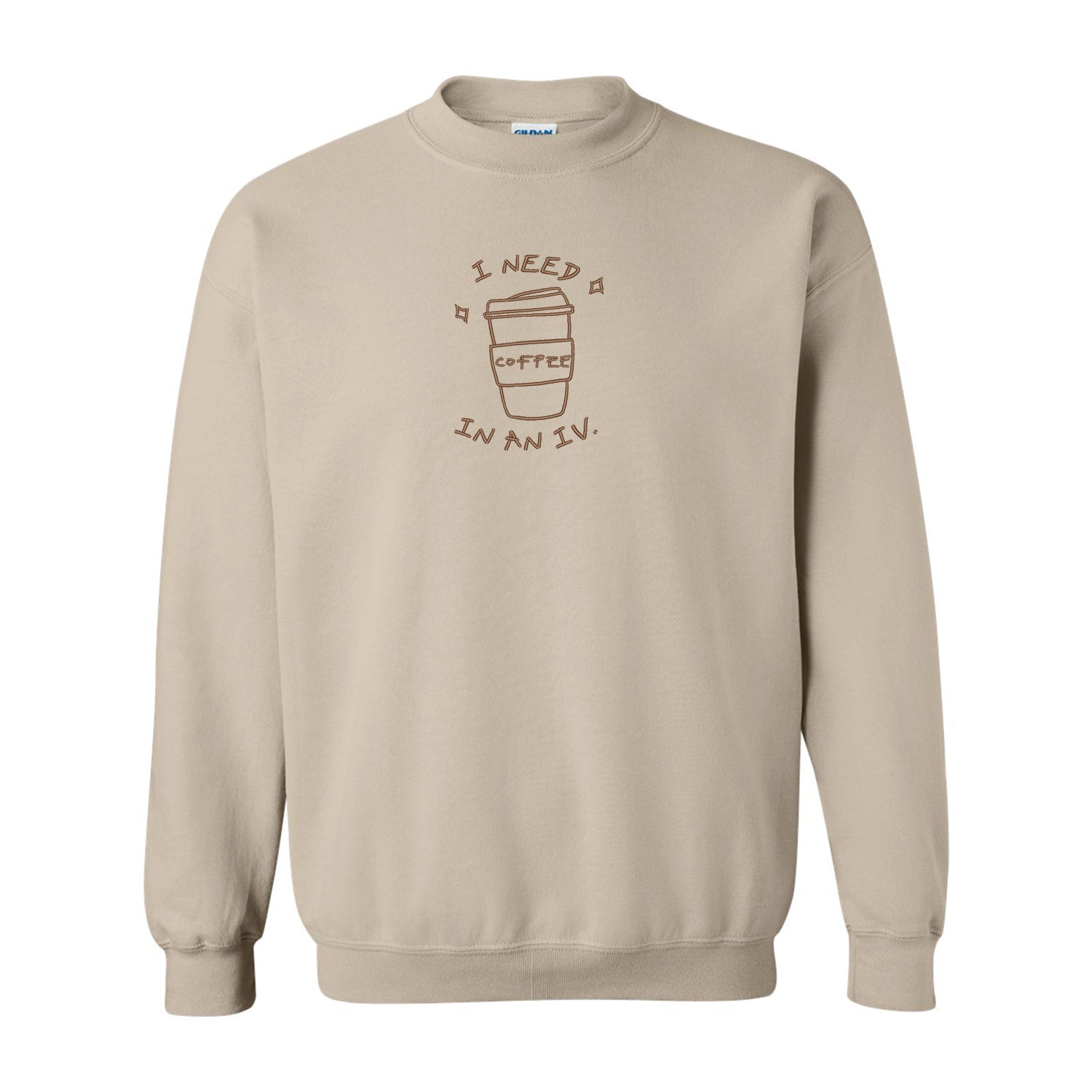 crewneck beige avec une broderie de café brune centrée sur le chandail